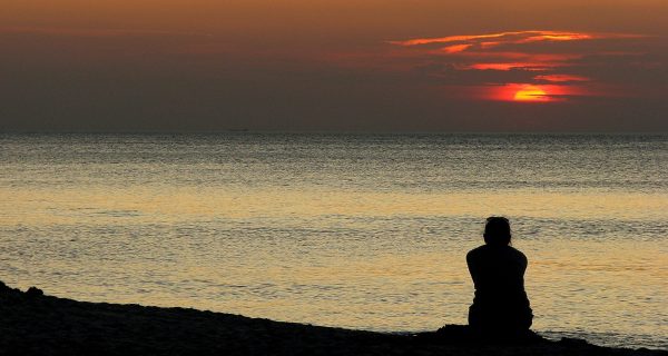 Canva - person sitting alone