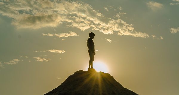 Canva - Silhouette of a Man Standing on a Mountain
