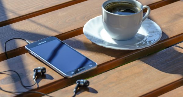 cropped-Canva-Coffee-and-Mobile-Phone-with-Earphones-Outdoors.jpg