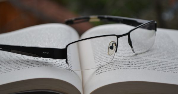 Canva - Clear Eyeglasses With Black Frames on Opened Book