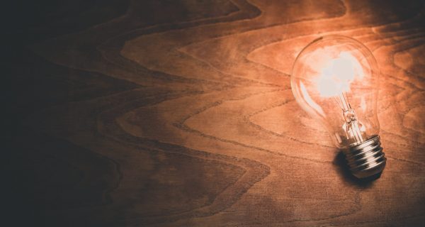 Canva - Light Bulb on Wooden Background