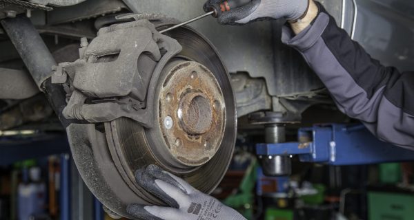 Canva – Mechanic Fixing the Brake Disc Canva - Mechanic Fixing the Brake Disc