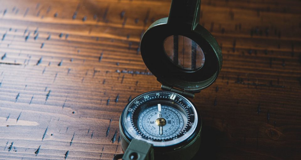 Canva - Compass On Brown Wooden Table
